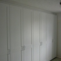 Bespoke built in Bedroom furniture covering existing chimney breast